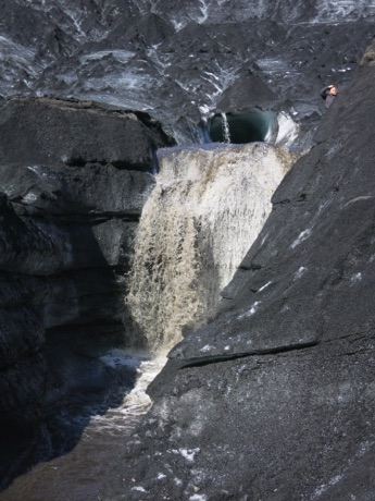 waterfall from melting ice before cave